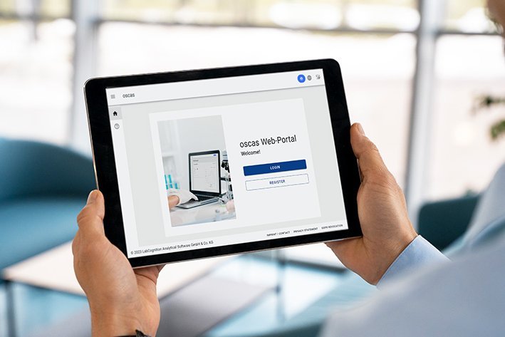Login providing various user roles Person holding a tablet that displays the login mask of the oscas software